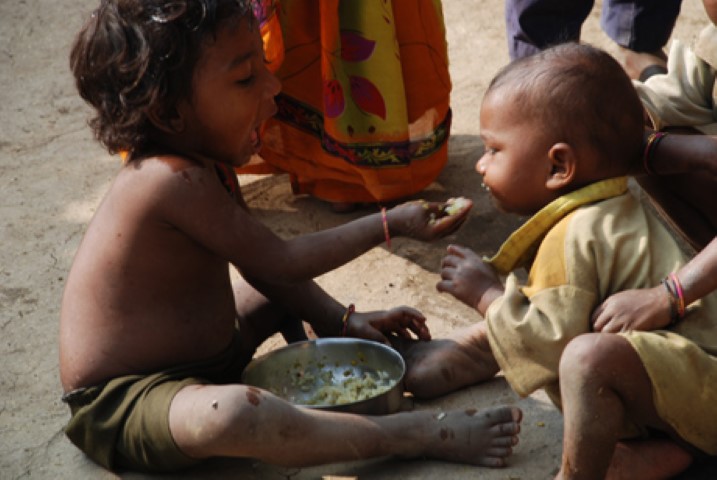 small child feeding another child